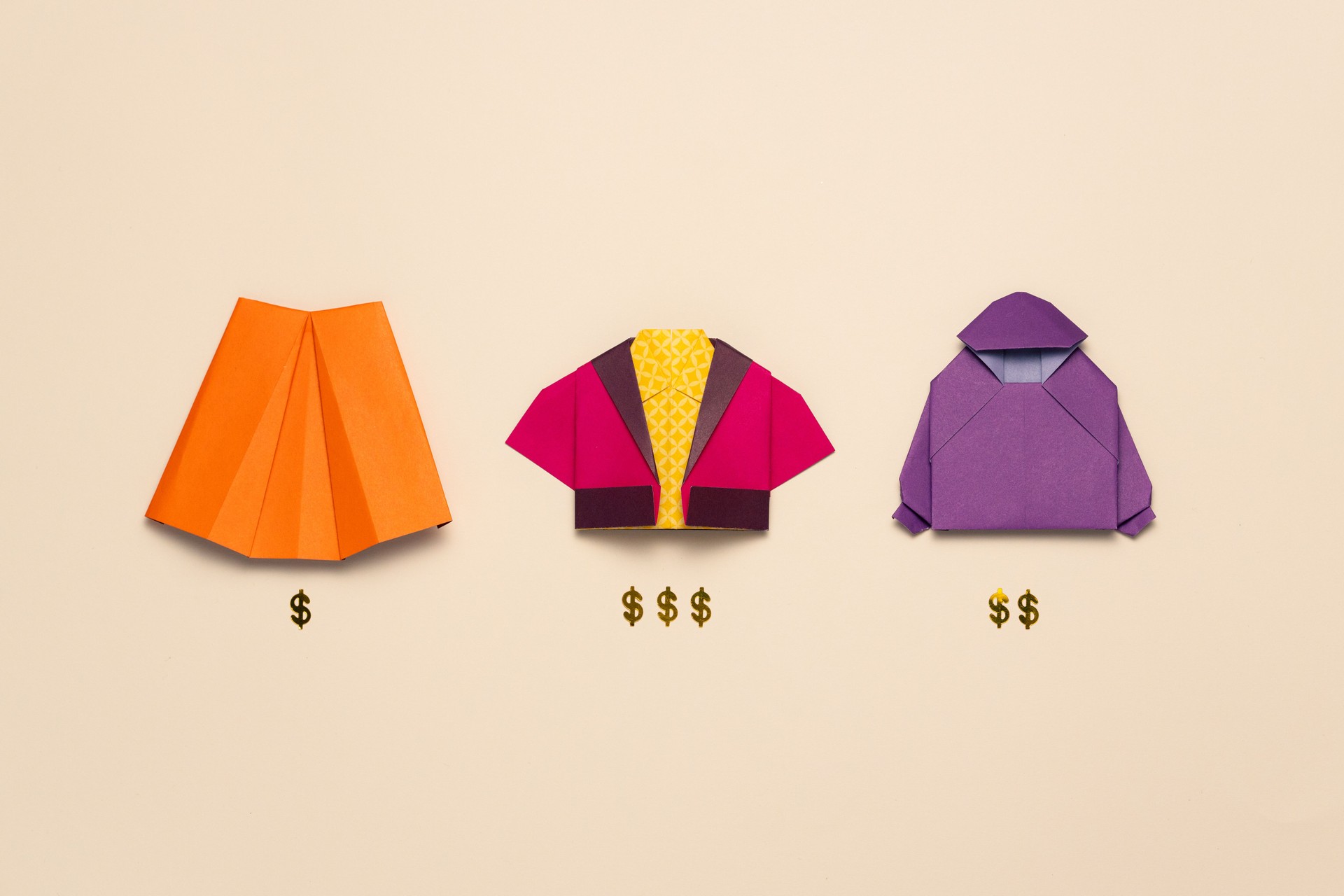 Origami paper clothes with dollar signs. Fashion prices, shopping and value differences